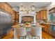 Bright kitchen boasts an island with seating and granite countertops at 590 Cumberland Rd, Larkspur, CO 80118