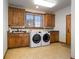 Laundry room with washer, dryer, and ample cabinetry at 590 Cumberland Rd, Larkspur, CO 80118