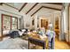 Open living room with hardwood floors, and a view into the kitchen at 590 Cumberland Rd, Larkspur, CO 80118