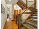 Elegant wooden staircase with metal railing and hardwood floors at 590 Cumberland Rd, Larkspur, CO 80118