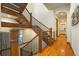Impressive wooden staircase with wrought iron railing at 590 Cumberland Rd, Larkspur, CO 80118