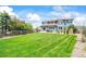 Expansive backyard featuring a well-kept lawn, outdoor seating area and manicured landscaping at 5238 Gould Cir, Castle Rock, CO 80109