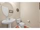Half bath featuring stylish pedestal sink, hardwood floors and decorative mirror at 5238 Gould Cir, Castle Rock, CO 80109