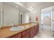 Bathroom with dual sinks, dark wood cabinetry, and neutral countertops at 5238 Gould Cir, Castle Rock, CO 80109