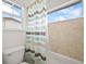 This bathroom features ceramic tile, a new toilet and striped shower curtain at 5238 Gould Cir, Castle Rock, CO 80109