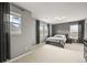 This bedroom features a queen bed, carpeted floor, gray walls and multiple windows at 5238 Gould Cir, Castle Rock, CO 80109