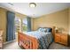 This bedroom features a wooden bedframe, an open window and yellow walls at 5238 Gould Cir, Castle Rock, CO 80109