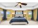 This bedroom features a tray ceiling, fan, and multiple windows that let in plenty of natural light at 5238 Gould Cir, Castle Rock, CO 80109