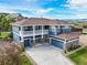 Stunning two-story home featuring a charming balcony, stone accents, and a spacious three-car garage at 5238 Gould Cir, Castle Rock, CO 80109