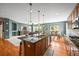 Open kitchen area with hardwood floors, large island, and stainless appliances at 5238 Gould Cir, Castle Rock, CO 80109