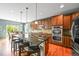 Modern kitchen featuring dark cabinets, granite countertops, a kitchen island, and stainless steel appliances at 5238 Gould Cir, Castle Rock, CO 80109