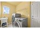 Laundry room featuring modern appliances, utility sink and bright paint at 5238 Gould Cir, Castle Rock, CO 80109