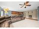 Open-concept living space features a fireplace, spacious couch, and kitchen with stainless steel appliances at 5238 Gould Cir, Castle Rock, CO 80109