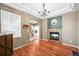 Living room featuring a charming fireplace, wood floors, natural light, and stylish accents at 5238 Gould Cir, Castle Rock, CO 80109