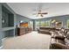 Cozy living room boasts plush carpeting, a ceiling fan, and multiple windows offering lots of natural light at 5238 Gould Cir, Castle Rock, CO 80109
