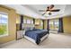 Bright main bedroom featuring a tray ceiling, plush carpet, multiple windows, and stylish decor at 5238 Gould Cir, Castle Rock, CO 80109