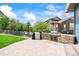 Back patio with a built-in stone grill and outdoor entertaining area at 5238 Gould Cir, Castle Rock, CO 80109