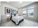 Bright bedroom featuring large windows, contemporary decor, and neutral color palette at 5150 N Quemoy Ct, Aurora, CO 80019