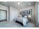 Well-lit bedroom boasts plush carpet, modern artwork, and a spacious closet at 5150 N Quemoy Ct, Aurora, CO 80019
