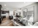 Bright open-concept dining area with glass table, seamlessly connecting to the kitchen and outdoor patio at 5150 N Quemoy Ct, Aurora, CO 80019