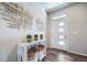 Inviting entryway with modern decor, stylish console table, and wood-look floors at 5150 N Quemoy Ct, Aurora, CO 80019