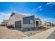 Attractive home featuring a blue and gray exterior, brick driveway, stone accents, and a well-manicured front yard at 5150 N Quemoy Ct, Aurora, CO 80019