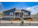 Beautiful home showcasing a blue exterior, stone accents, landscaped front yard, and a vibrant red front door at 5150 N Quemoy Ct, Aurora, CO 80019