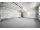 Spacious unfinished two-car garage ready for customization and ample storage at 5150 N Quemoy Ct, Aurora, CO 80019