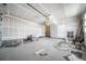 Spacious garage with concrete flooring, drywall, overhead lighting, and garage door access to the house at 5150 N Quemoy Ct, Aurora, CO 80019