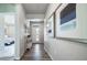 Hallway with attractive console table, modern art, and wood-look flooring leading to a bedroom at 5150 N Quemoy Ct, Aurora, CO 80019
