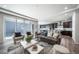 Sunlit living room with seamless integration of the living area, kitchen, and outdoor patio at 5150 N Quemoy Ct, Aurora, CO 80019