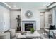 Bright living room featuring a fireplace, stylish decor, and comfortable seating at 5150 N Quemoy Ct, Aurora, CO 80019