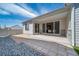 Covered patio features sliding glass doors and pavers at 5150 N Quemoy Ct, Aurora, CO 80019