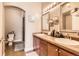 Bathroom with dual sinks, wood cabinets and a shower at 9019 E Panorama Cir # D207, Englewood, CO 80112