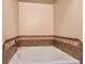 A cozy bathtub features a tile surround and silver fixtures at 9019 E Panorama Cir # D207, Englewood, CO 80112