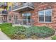 Well-maintained apartment building exterior with multiple balconies and manicured bushes at 9019 E Panorama Cir # D207, Englewood, CO 80112