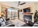Inviting living room featuring a cozy fireplace and sliding glass doors to private balcony at 9019 E Panorama Cir # D207, Englewood, CO 80112