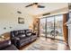 Comfortable living room features a sliding glass door that leads to a balcony at 9019 E Panorama Cir # D207, Englewood, CO 80112