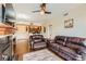 Open-concept living room with a fireplace and hardwood floors, seamlessly flowing into the kitchen at 9019 E Panorama Cir # D207, Englewood, CO 80112
