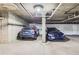 Well lit parking garage showcasing parking spaces and concrete pillars at 9019 E Panorama Cir # D207, Englewood, CO 80112