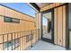 Balcony view showcasing modern architecture with cedar wood siding and black window frames at 1601 Park Ave # 307, Denver, CO 80218