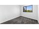 Cozy bedroom featuring gray carpet, a large window, and neutral wall color at 1601 Park Ave # 307, Denver, CO 80218
