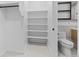 Walk-in closet featuring shelving and tile floor, adjoined with the bathroom at 1601 Park Ave # 307, Denver, CO 80218