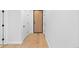 Clean hallway featuring hardwood floors, doors, and modern trim at 1601 Park Ave # 307, Denver, CO 80218