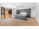 Well-lit modern kitchen with island and hardwood floors at 1601 Park Ave # 307, Denver, CO 80218