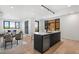 Bright, open-concept kitchen with island, stainless steel appliances, and dining area at 1601 Park Ave # 307, Denver, CO 80218
