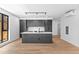 Spacious open floor plan kitchen with a large center island and hardwood floors at 1601 Park Ave # 307, Denver, CO 80218