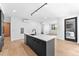 Open kitchen with large island, stylish black fixtures, and stainless steel appliances at 1601 Park Ave # 307, Denver, CO 80218