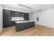 Open kitchen design featuring a large island, modern lighting, and stainless appliances at 1601 Park Ave # 307, Denver, CO 80218