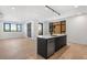 Open living and dining area with modern kitchen featuring stainless steel appliances and hardwood floors at 1601 Park Ave # 307, Denver, CO 80218